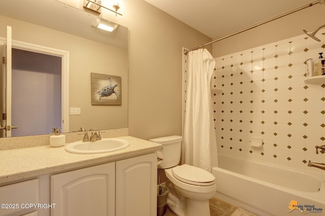 full bathroom featuring tile patterned floors, shower / bath combo with shower curtain, toilet, and vanity