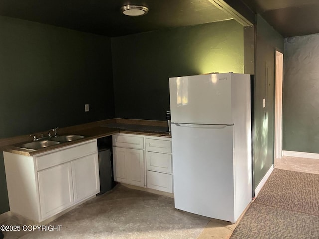 000 Barbara St, Sterling, AK 99672 - kitchen featuring freestanding refrigerator, white cabinetry, dark countertops, and a sink