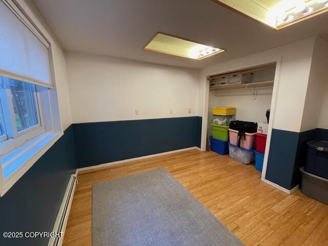 interior space featuring light wood-style flooring and a baseboard radiator