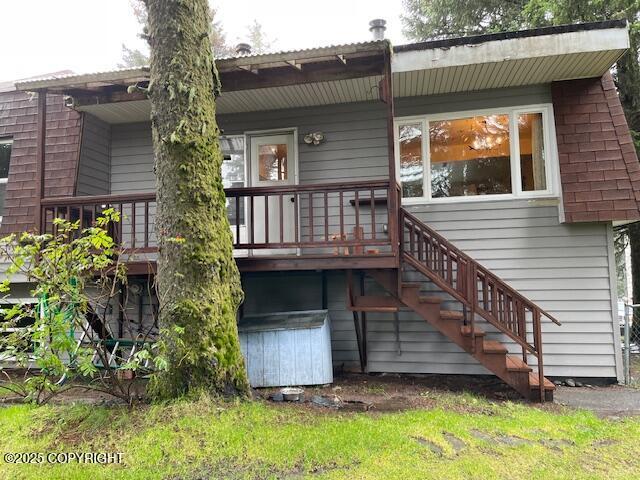 rear view of property with stairway