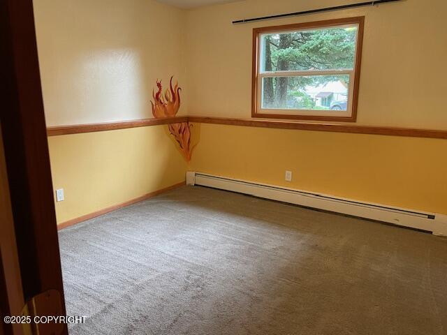 unfurnished room with carpet flooring, baseboards, and baseboard heating