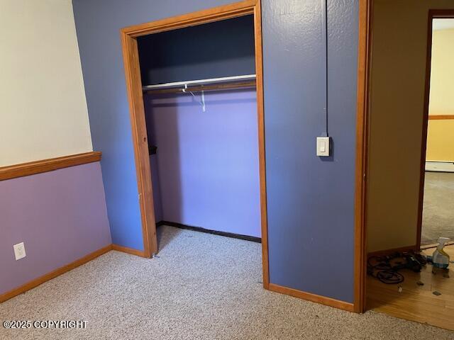 closet with a baseboard heating unit