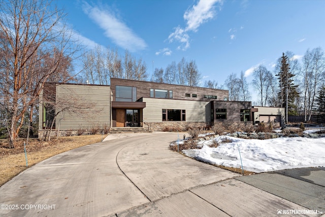 1665 Bob Atwood Cir, Anchorage, AK 99517 - view of front of house featuring stone siding and concrete driveway