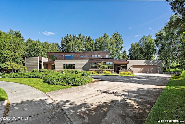 1665 Bob Atwood Cir, Anchorage, AK 99517 - modern home with concrete driveway and an attached garage