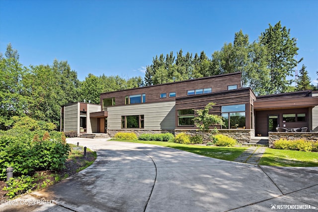 1665 Bob Atwood Cir, Anchorage, AK 99517 - view of front facade with stone siding and curved driveway