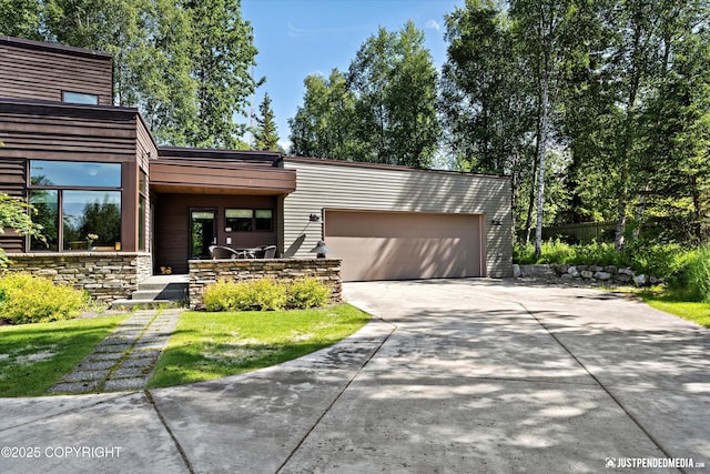 1665 Bob Atwood Cir, Anchorage, AK 99517 - contemporary house featuring concrete driveway and an attached garage