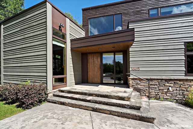 1665 Bob Atwood Cir, Anchorage, AK 99517 - doorway to property featuring stone siding