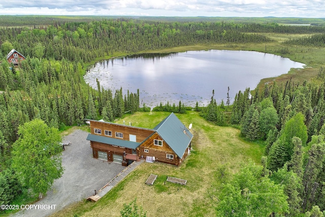 aerial view with a wooded view and a water view