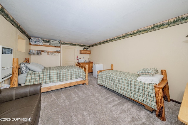 carpeted bedroom featuring baseboards and heating unit