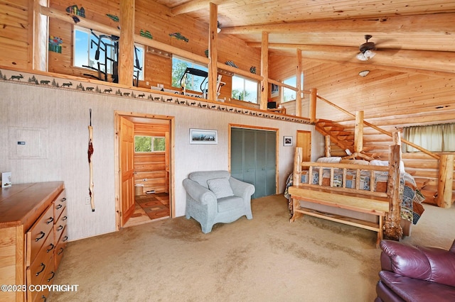 carpeted bedroom featuring beam ceiling, high vaulted ceiling, and log walls