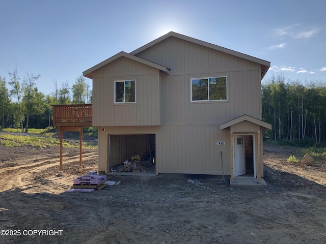 view of front of house featuring a garage and a deck