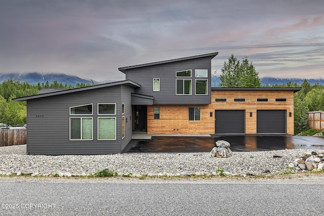 9475 E Spring Creek Cir, Wasilla, AK 99654 - contemporary home featuring an attached garage and asphalt driveway