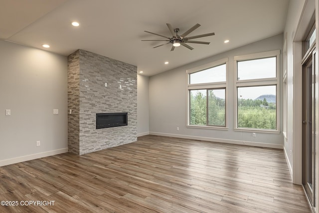 9475 E Spring Creek Cir, Wasilla, AK 99654 - unfurnished living room featuring a ceiling fan, a fireplace, wood finished floors, recessed lighting, and baseboards