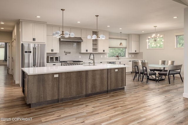 9475 E Spring Creek Cir, Wasilla, AK 99654 - kitchen with stainless steel refrigerator with ice dispenser, a chandelier, light countertops, decorative backsplash, and recessed lighting