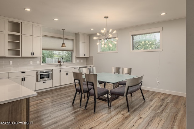 9475 E Spring Creek Cir, Wasilla, AK 99654 - dining area with healthy amount of natural light, light wood finished floors, a chandelier, recessed lighting, and baseboards