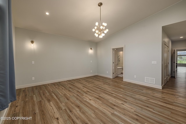9475 E Spring Creek Cir, Wasilla, AK 99654 - unfurnished room featuring wood finished floors, a chandelier, baseboards, vaulted ceiling, and recessed lighting