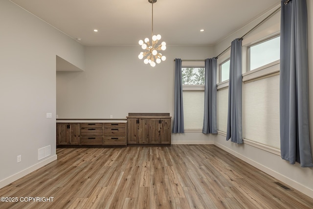 9475 E Spring Creek Cir, Wasilla, AK 99654 - unfurnished dining area with light wood-type flooring, baseboards, a chandelier, and recessed lighting