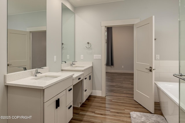 9475 E Spring Creek Cir, Wasilla, AK 99654 - full bath with double vanity, wood finished floors, a freestanding bath, and baseboards