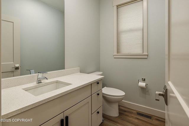 9475 E Spring Creek Cir, Wasilla, AK 99654 - half bath featuring toilet, wood finished floors, vanity, and baseboards