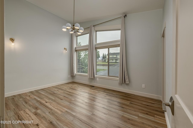 9475 E Spring Creek Cir, Wasilla, AK 99654 - spare room with light wood-type flooring, a chandelier, baseboards, and lofted ceiling