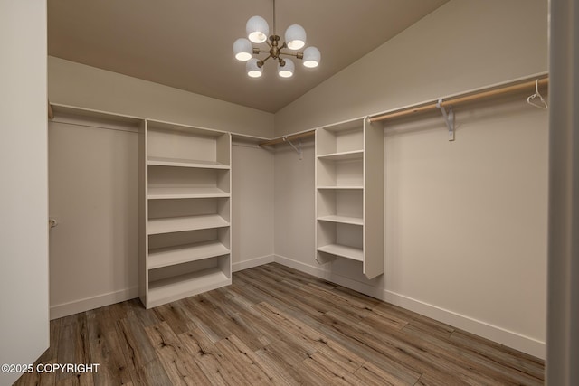 9475 E Spring Creek Cir, Wasilla, AK 99654 - spacious closet featuring a chandelier, wood finished floors, and lofted ceiling