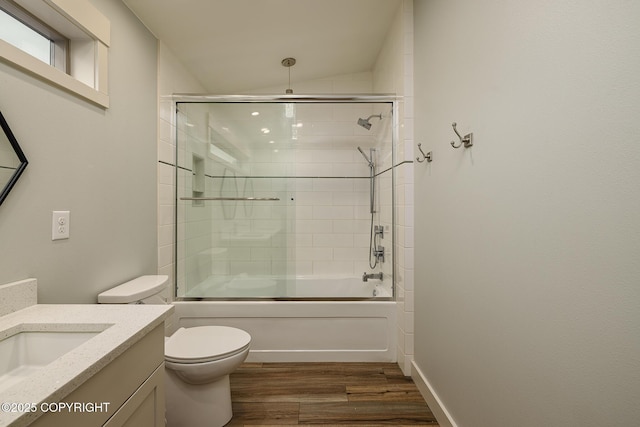 9475 E Spring Creek Cir, Wasilla, AK 99654 - bathroom featuring vanity, toilet, wood finished floors, combined bath / shower with glass door, and vaulted ceiling