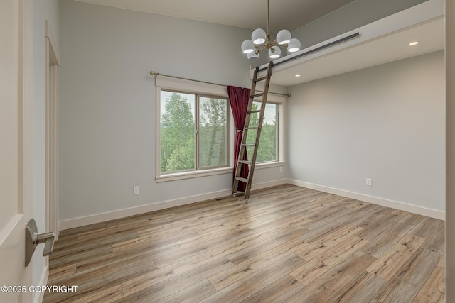 9475 E Spring Creek Cir, Wasilla, AK 99654 - empty room with a chandelier, wood finished floors, baseboards, and recessed lighting