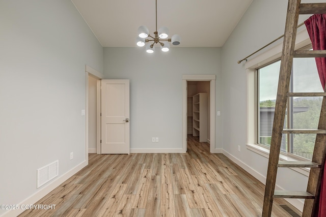 9475 E Spring Creek Cir, Wasilla, AK 99654 - unfurnished room featuring a chandelier, light wood-type flooring, and baseboards