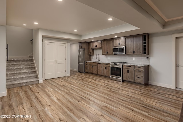 9475 E Spring Creek Cir, Wasilla, AK 99654 - kitchen featuring appliances with stainless steel finishes, recessed lighting, a raised ceiling, light wood finished floors, and baseboards
