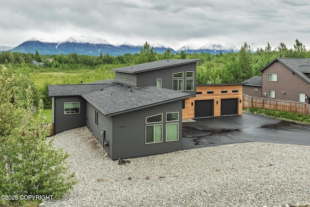 9475 E Spring Creek Cir, Wasilla, AK 99654 - rear view of house featuring a mountain view, a detached garage, and roof with shingles