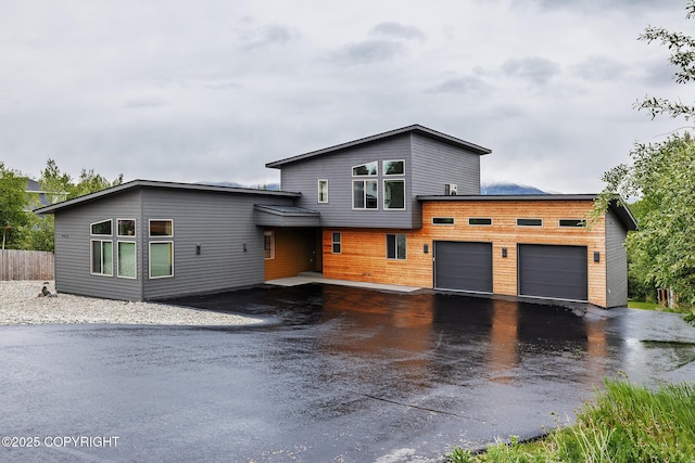 9475 E Spring Creek Cir, Wasilla, AK 99654 - modern home with an attached garage and asphalt driveway