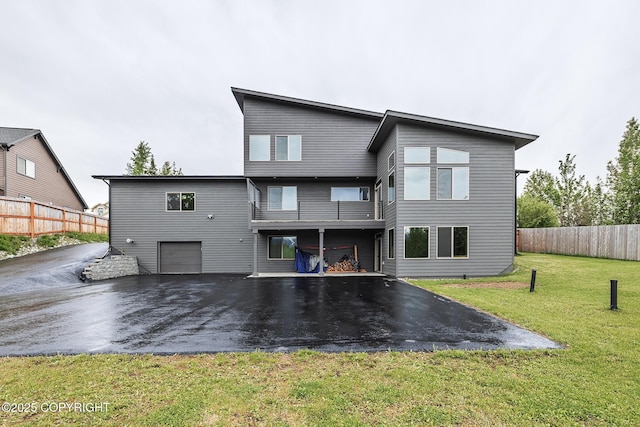 9475 E Spring Creek Cir, Wasilla, AK 99654 - back of house with driveway, an attached garage, and a balcony