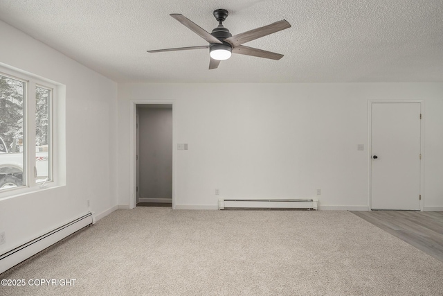 empty room featuring carpet flooring, baseboards, baseboard heating, and a textured ceiling