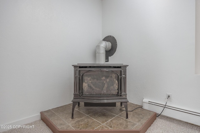 interior details with a wood stove, baseboards, and a baseboard radiator