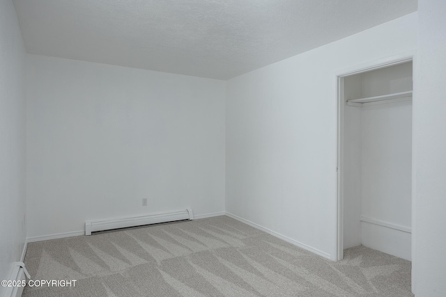 unfurnished bedroom featuring a baseboard radiator, a textured ceiling, and carpet flooring