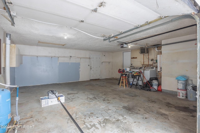 garage featuring washing machine and dryer and a garage door opener