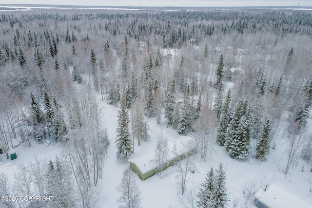 snowy aerial view featuring a view of trees