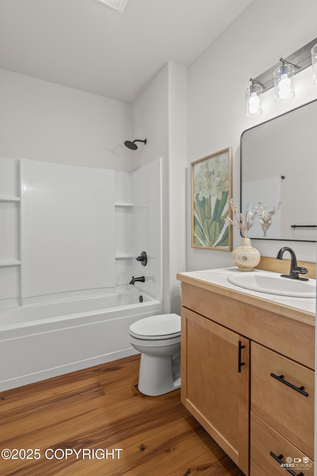 full bathroom featuring vanity,  shower combination, toilet, and wood finished floors