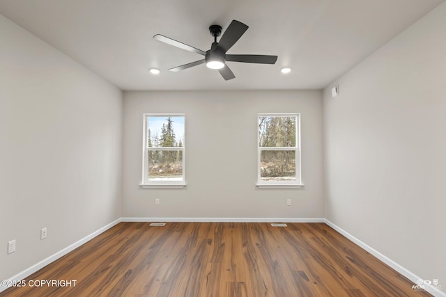 spare room featuring ceiling fan, baseboards, dark wood-style floors, and recessed lighting