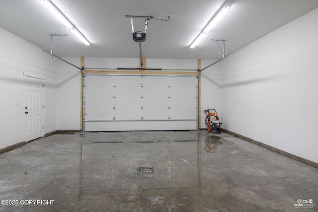 garage featuring baseboards and a garage door opener