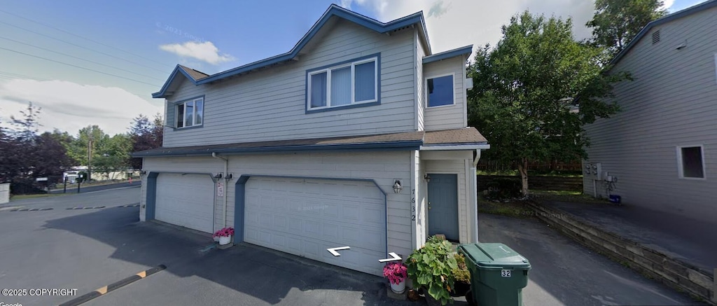 view of property exterior with a garage and driveway