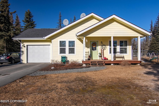 view of front facade featuring a porch, an attached garage, and concrete driveway