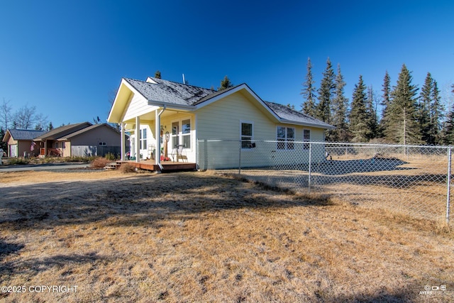 view of home's exterior featuring a porch and fence