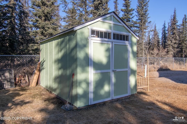 view of shed with fence