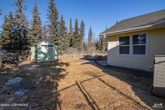 view of yard featuring an outbuilding, a storage shed, a fenced backyard, and a patio area