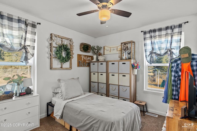 carpeted bedroom with visible vents, ceiling fan, and baseboards