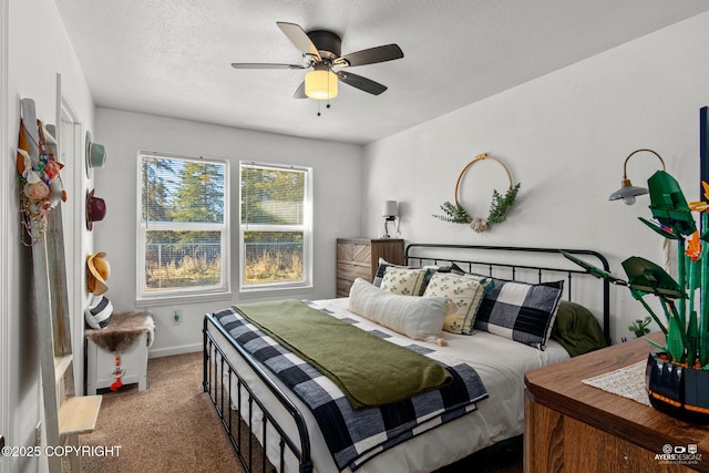 bedroom featuring baseboards, carpet, ceiling fan, and a textured ceiling