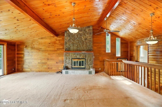 24508 Reese Rd, Chugiak, AK 99567 - unfurnished living room with carpet floors, wooden ceiling, wooden walls, a stone fireplace, and a ceiling fan