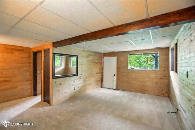 24508 Reese Rd, Chugiak, AK 99567 - carpeted spare room with wood walls and beam ceiling