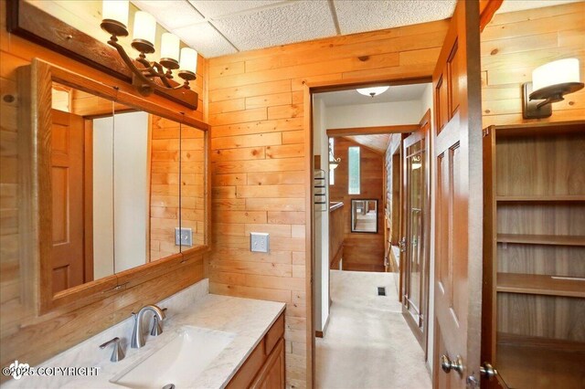 24508 Reese Rd, Chugiak, AK 99567 - bathroom with wooden walls and vanity